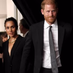 Prince Harry and Meghan Markle walk hand-in-hand as they arrive at glitzy awards ceremony – just hours after King Charles and Prince William put on united front