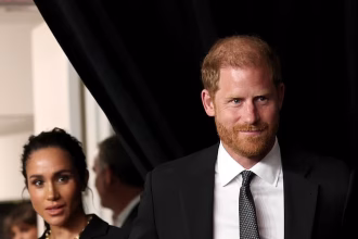 Prince Harry and Meghan Markle walk hand-in-hand as they arrive at glitzy awards ceremony – just hours after King Charles and Prince William put on united front