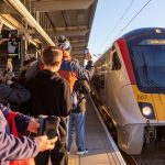 Crowds clap and cheer train arriving at first new station for 100 years