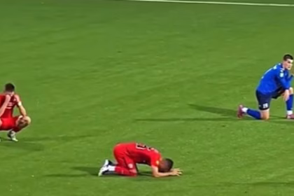 The heartbreaking moment top-flight footballers collapse as they are told their manager, 44, has died mid-match after heart attack in the dug-out