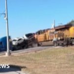 Moment train collides with lorry carrying vehicles in Texas