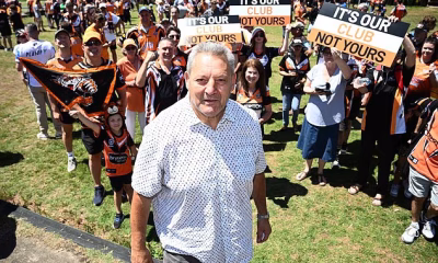 Fed-up Wests Tigers fans take to the streets for rally and DEMAND Holman Barnes Group resign from NRL club