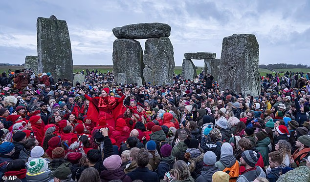 Thousands gather at Stonehenge to celebrate winter solstice: Crowds gather at historic monument for sunrise on shortest day of the year