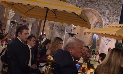Shy Barron Trump keeps to himself as he sits next to his father at Mar-a-Lago festive dinner