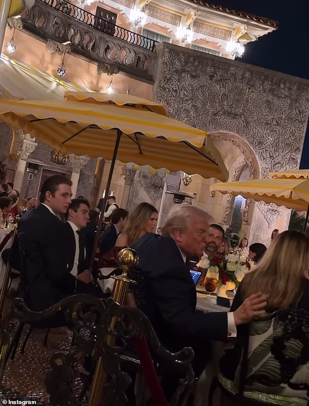 Shy Barron Trump keeps to himself as he sits next to his father at Mar-a-Lago festive dinner