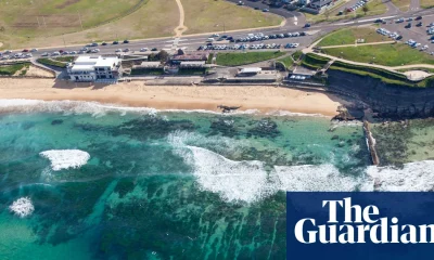 Man charged with displaying Nazi hate symbol after showing off tattoos at NSW beach | New South Wales